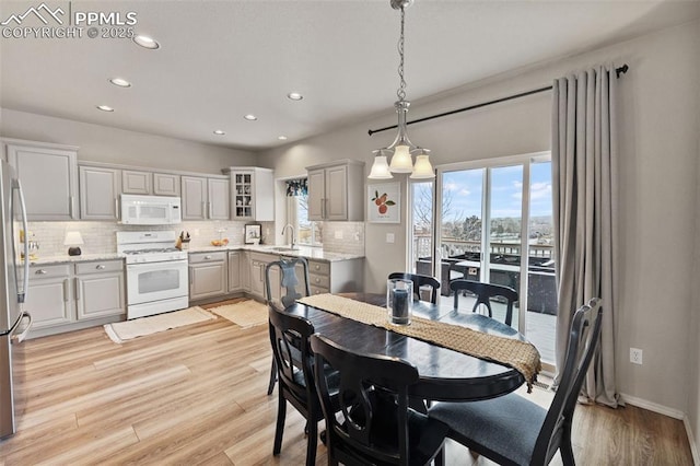 dining area featuring sink and light hardwood / wood-style floors