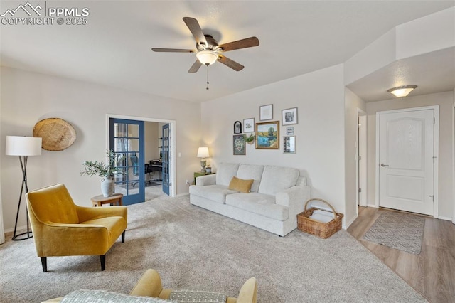 living room with ceiling fan, light wood-type flooring, and french doors