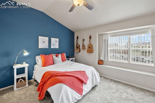 carpeted bedroom with ceiling fan and vaulted ceiling