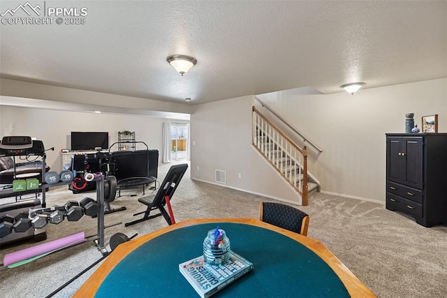 interior space featuring carpet floors and a textured ceiling