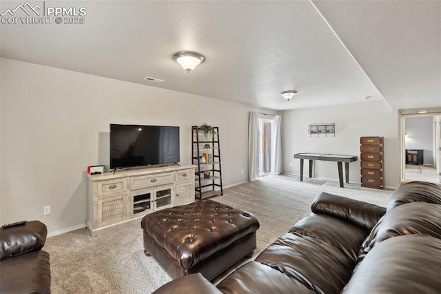 carpeted living room with a textured ceiling