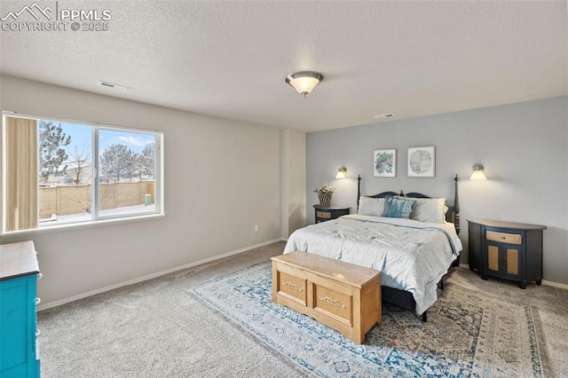 carpeted bedroom featuring a textured ceiling