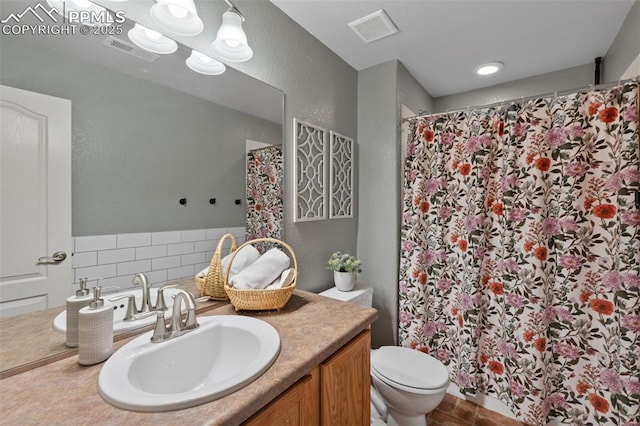 bathroom featuring vanity, a shower with curtain, and toilet