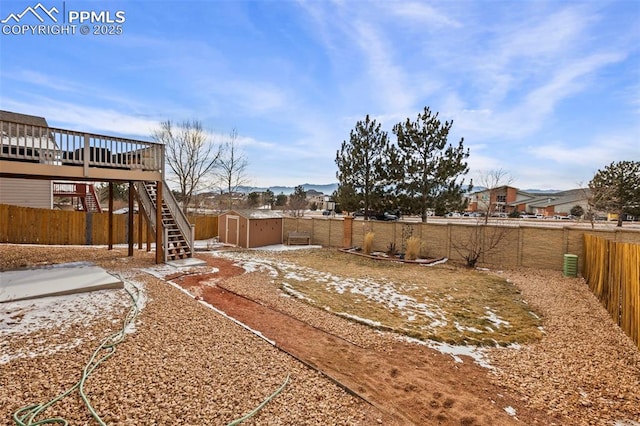 view of yard with a storage unit and a deck