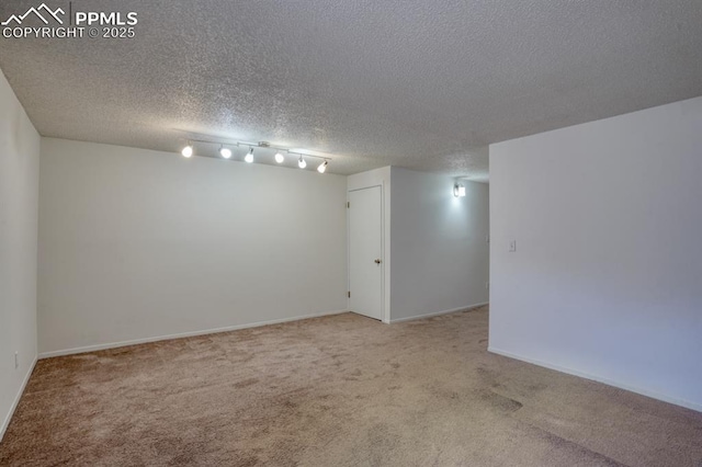 carpeted spare room featuring a textured ceiling