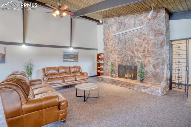 living room with a high ceiling, a stone fireplace, carpet flooring, and beam ceiling