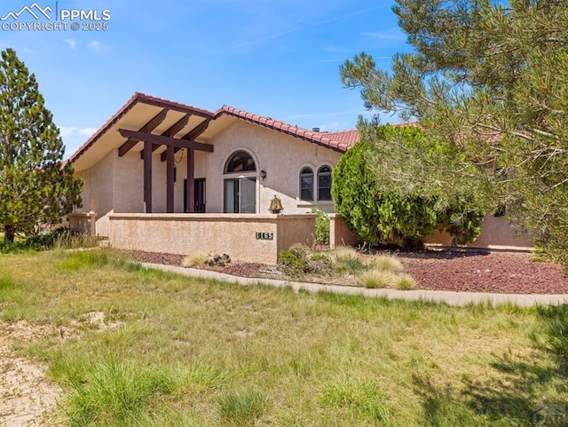 exterior space with a tile roof and stucco siding