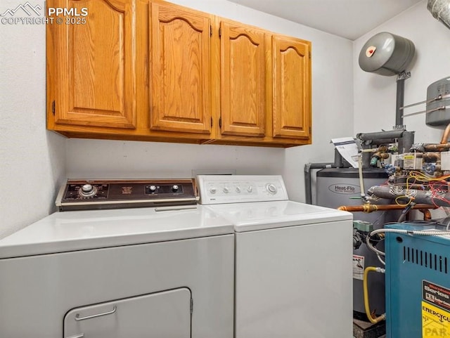 clothes washing area with water heater, washing machine and clothes dryer, and cabinet space