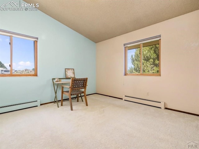 interior space featuring light colored carpet, a baseboard heating unit, vaulted ceiling, a textured ceiling, and baseboards