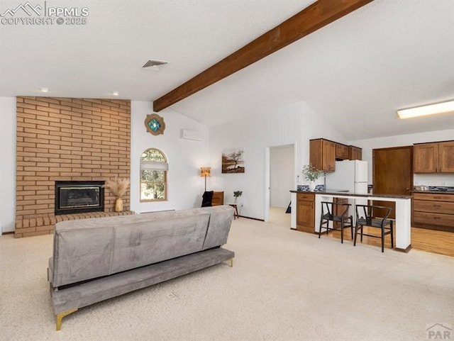 living area with visible vents, lofted ceiling with beams, a brick fireplace, light carpet, and a textured ceiling