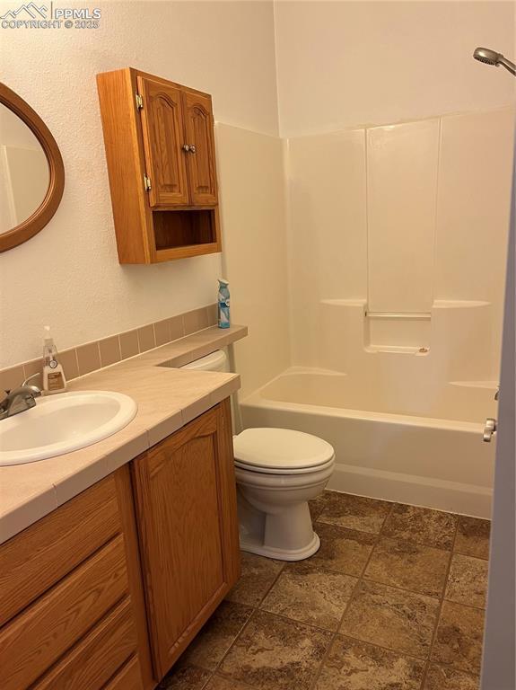 full bathroom with vanity, toilet, and shower / bathing tub combination