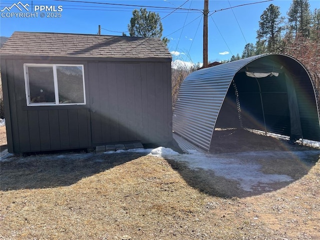 view of side of property featuring an outbuilding