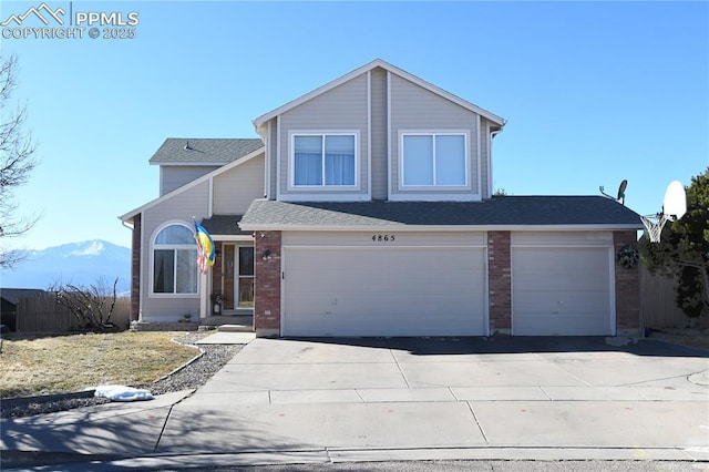 view of property featuring a garage and a mountain view