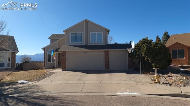 front facade with a garage and a mountain view