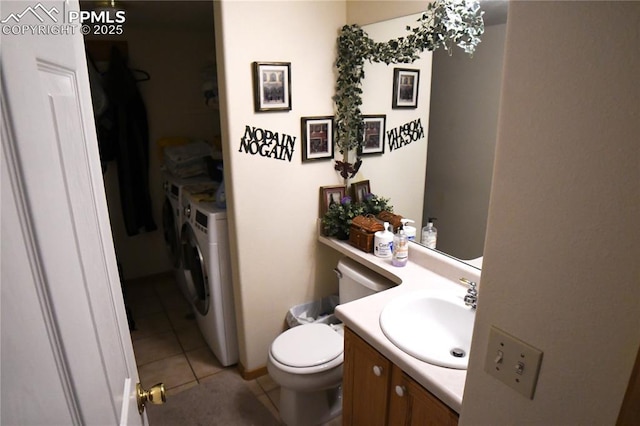 bathroom with vanity, tile patterned flooring, independent washer and dryer, and toilet