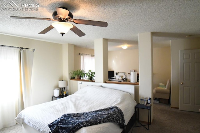 carpeted bedroom with ceiling fan and a textured ceiling