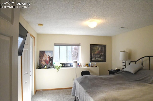 carpeted bedroom featuring a textured ceiling