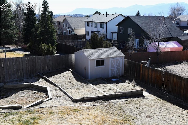 view of yard featuring a storage shed and a mountain view