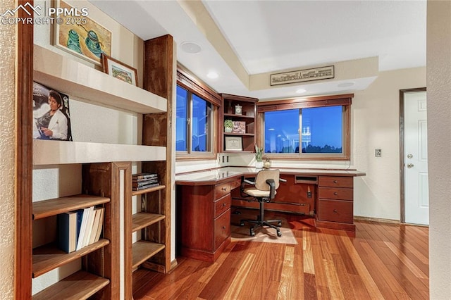 office area featuring built in desk and light wood-type flooring