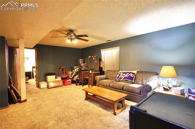 living room featuring ceiling fan, a textured ceiling, visible vents, and carpet flooring