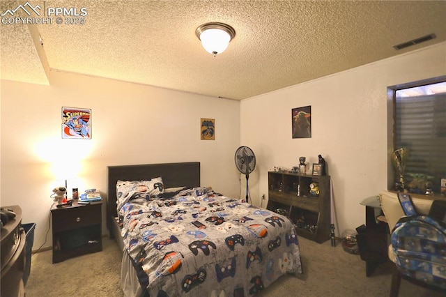 bedroom featuring visible vents, a textured ceiling, and light colored carpet