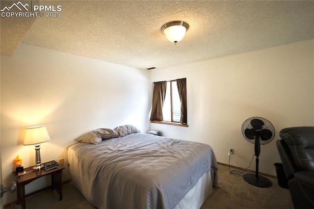 bedroom featuring carpet, visible vents, a textured ceiling, and baseboards