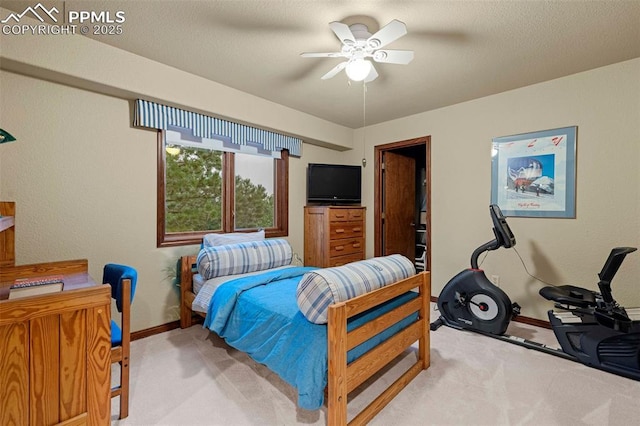 bedroom featuring light colored carpet, a ceiling fan, and baseboards