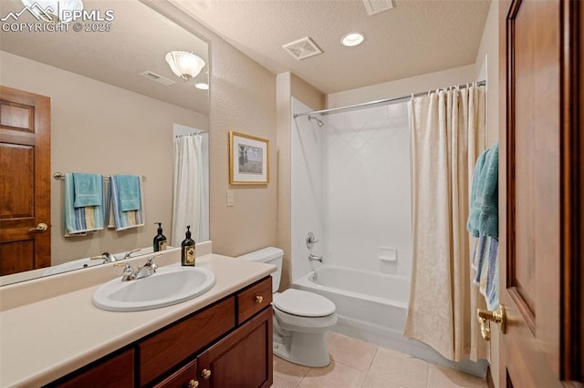 bathroom featuring tile patterned floors, visible vents, toilet, and a textured ceiling