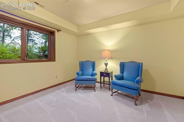 living area featuring visible vents, baseboards, and carpet floors