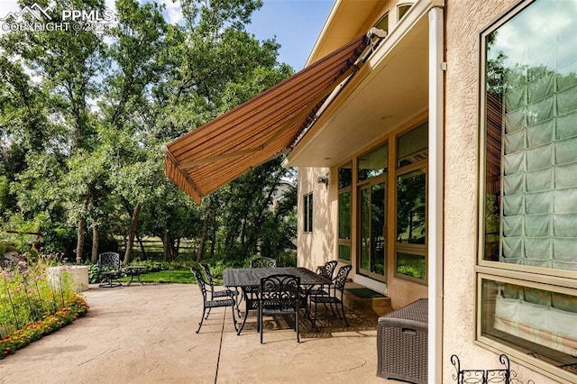 view of patio / terrace featuring outdoor dining space and fence