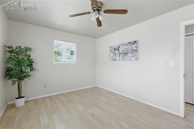 unfurnished room featuring light wood finished floors, baseboards, and a ceiling fan