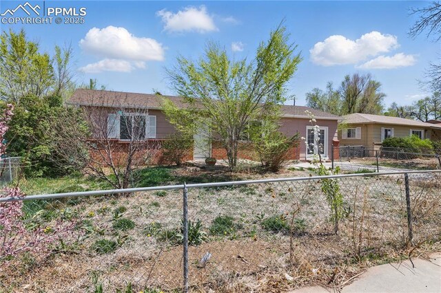 ranch-style home with fence private yard and brick siding