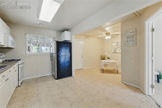 kitchen with white cabinets, baseboards, ceiling fan, white appliances, and light floors