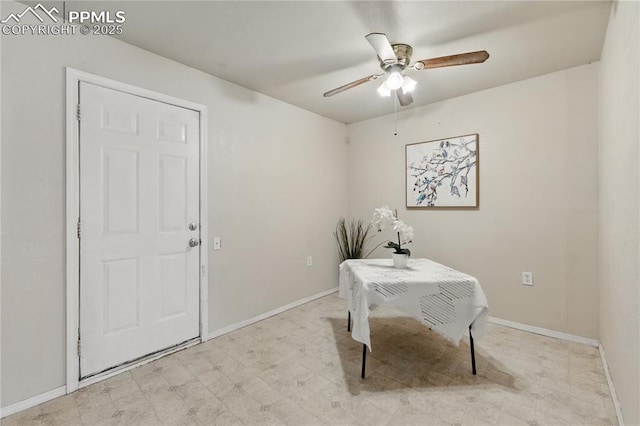 office featuring baseboards, a ceiling fan, and light floors