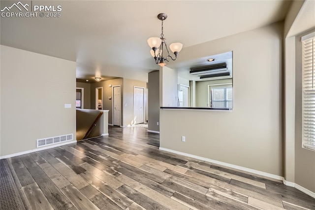 interior space featuring a notable chandelier and dark hardwood / wood-style floors