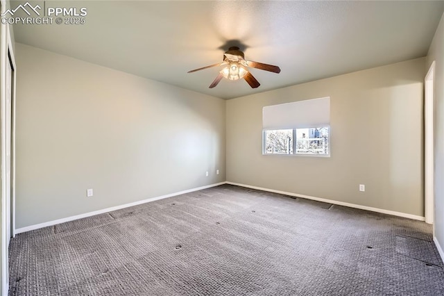 carpeted spare room featuring ceiling fan