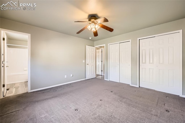 unfurnished bedroom with multiple closets, ceiling fan, carpet flooring, and ensuite bath