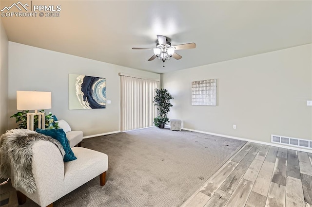 sitting room featuring hardwood / wood-style floors and ceiling fan