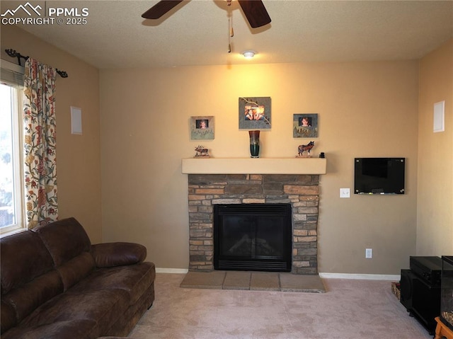 living room with ceiling fan, a healthy amount of sunlight, light colored carpet, and a fireplace