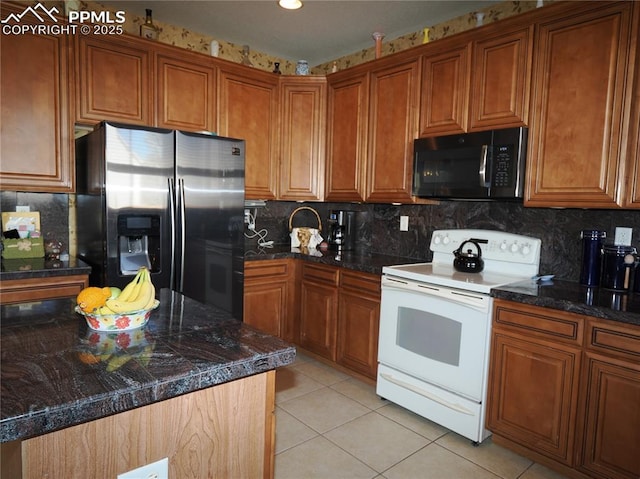 kitchen with backsplash, white range with electric cooktop, stainless steel fridge, and light tile patterned floors