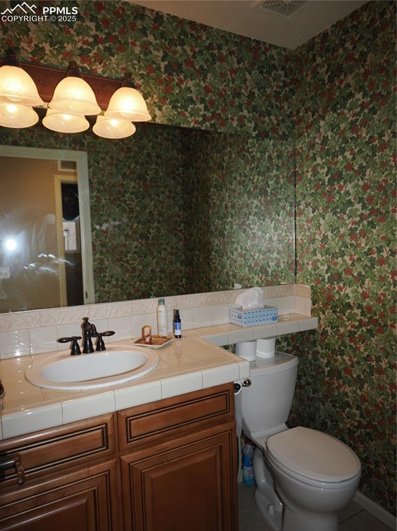 bathroom with vanity and toilet