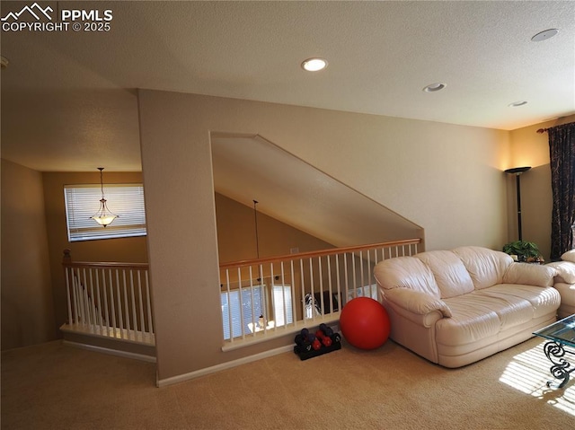 living room featuring lofted ceiling, carpet flooring, a textured ceiling, and plenty of natural light