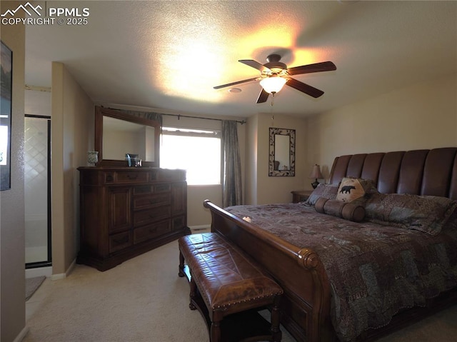 bedroom with ceiling fan, light colored carpet, and a textured ceiling