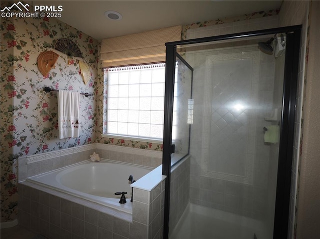 bathroom with separate shower and tub