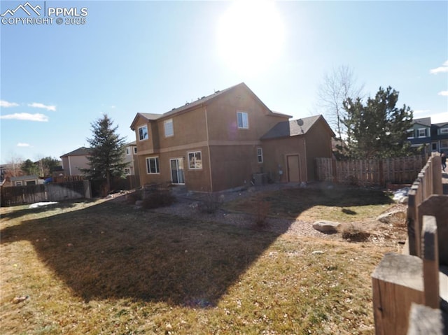 rear view of house featuring a lawn