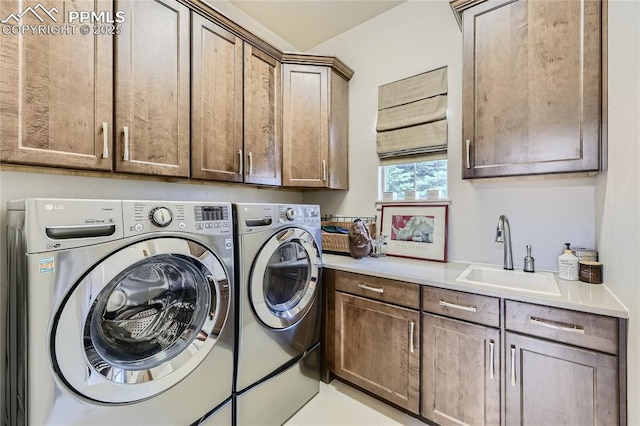 laundry area with cabinets, sink, and independent washer and dryer