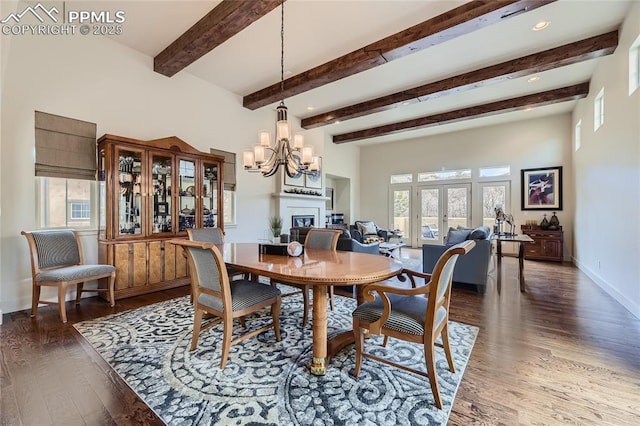 dining space with beamed ceiling, dark wood-type flooring, an inviting chandelier, and french doors