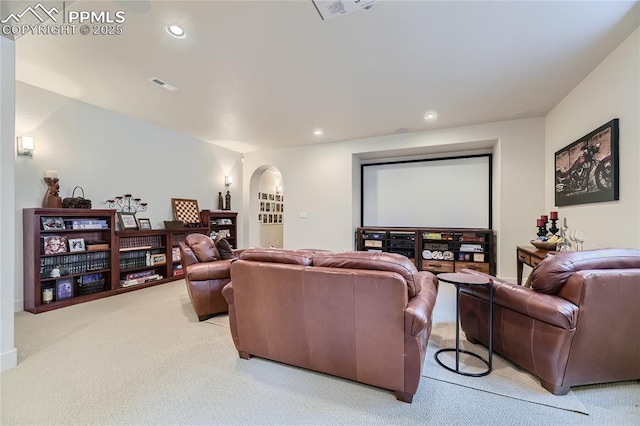 cinema room featuring light carpet