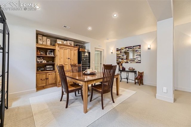 dining room featuring light carpet