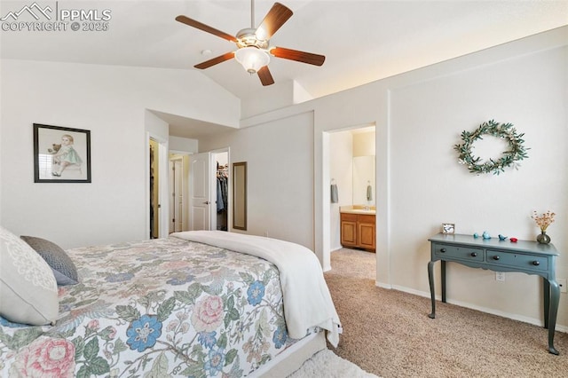 bedroom with lofted ceiling, a spacious closet, ensuite bathroom, ceiling fan, and light colored carpet